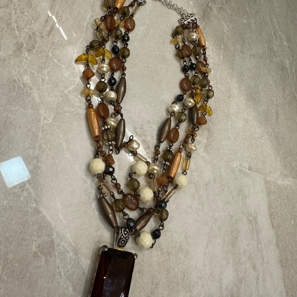 Multi-strand beaded necklace with a touch of brown and green hues. - Picture 7 of 7